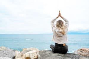 a-woman-practicing-yoga-on-the-beach